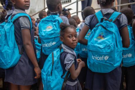 Students Dame Marie school in Grand'Anse, Haiti, carry UNICEF backpacks containing school supplies.