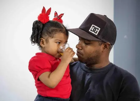 A little girl and her dad attend a UNICEF-supported early childhood development program in San Agustin, Caracas, Venezuela, on March 14, 2023.