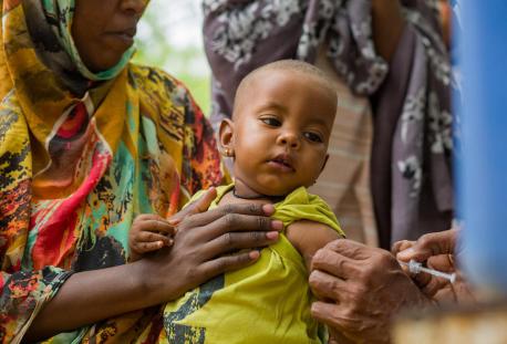 On June 5, 2023, Ibtisam Abdullah, a vaccinator at Gezirat Al-Feel Health Center in Sudan vaccinates a child at a shelter for displaced people.