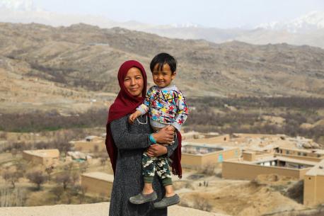 A teacher with her son standing her rooftop in Afghanistan