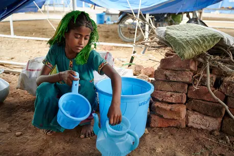 8-year-old Geetu of Umerkot, Sindh province, Pakistan, organizes items that came with the hygiene kit her family received from UNICEF as part of emergency relief to families impacted by the summer 2022 floods.