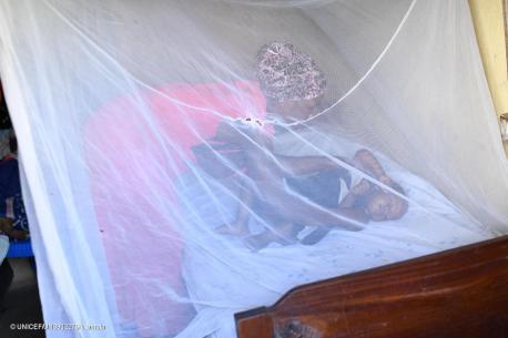 A mother puts her baby to sleep under an anti-malarial bednet provided by UNICEF at their home in Kabingo village, Ntungamo district, Uganda.