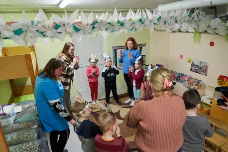 Kindergarten teachers conduct lessons with children in a basement bomb shelter renovated by UNICEF in Slavutych, Ukraine.