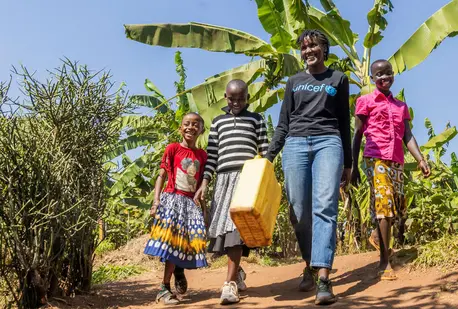 UNICEF Goodwill Ambasador Vanessa Nakate walks with (from left) Bonette, Graciella and Adele in Kigarama Sector, Kirehe District, Eastern Province of Rwanda.
