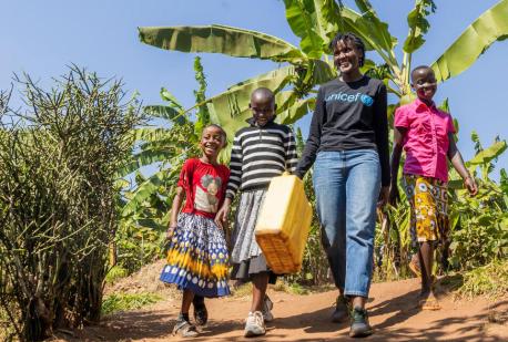 UNICEF Goodwill Ambasador Vanessa Nakate walks with (from left) Bonette, Graciella and Adele in Kigarama Sector, Kirehe District, Eastern Province of Rwanda. 