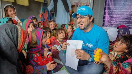 Bahir Wyaar, a UNICEF Education Specialist, plays with survivors of June’s devastating earthquake at a recently established UNICEF-supported Child Friendly Space in Gayan District, Paktika Province, Afghanistan.