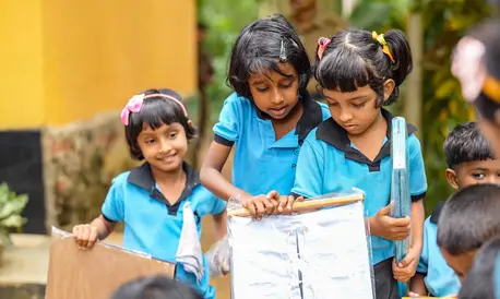 Children at a pre-school opening a box of games and learning materials handed over by UNICEF Regional Goodwill Ambassador for South Asia, Sachin Tendulkar.