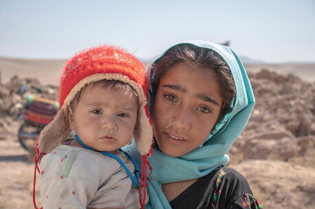 On Oct.10, 2023, 10-year-old Zari holds her brother Marv, 8 months old, in front of their house, which collapsed during an earthquake that hit Zindajan district, Herat Province, Afghanistan on Oct. 7.