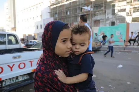 On Oct. 17, 2023, children evacuate their home in northern Gaza, seeking refuge in the southern region..