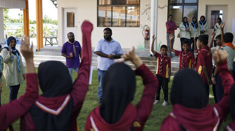Maeed Zahir, Climate Resilience Consultant for UNICEF Maldives, leads a student activity about climate change at Ihaddhoo School in Gan, Laamu Atoll.