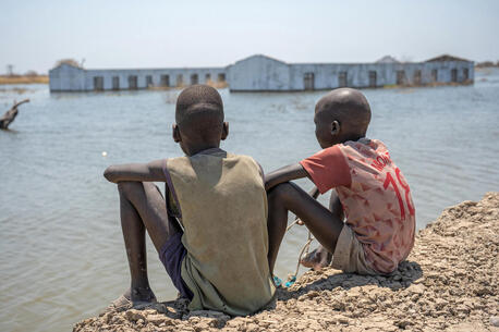 Two boys look out at their flooded school in Bentiu, Unity State, South Sudan, an area that suffered extensive flooding, an impact of climate change.