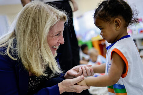 On Aug. 30, 2023, UNICEF Executive Director Catherine Russell greets a young student at the Ibura neighborhood school in the city of Recife, Brazil.