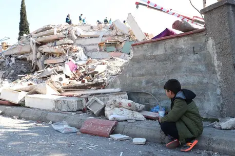Berat, 9, waits for his friend to be rescued from the rubble after an earthquake rocked Kahramanmaraş, Türkiye..