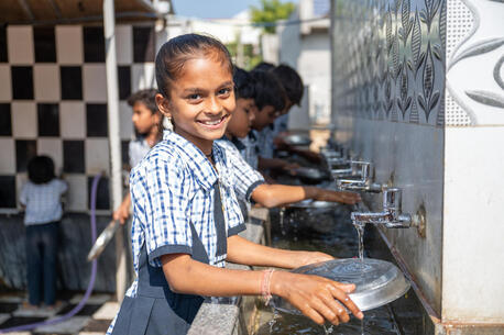 A student washes up at Vadodara Primary School in Dabhoda, Gujarat, India.