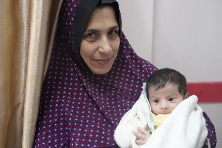 On Jan. 16, 2024, Qazala holds her 1-month-old son, Khaled, who was born here at Nasser hospital in Khan Younis, the largest remaining functioning medical center in the Gaza Strip.