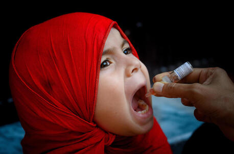 A girl receives the polio vaccine in Rawalpindi, Pakistan.