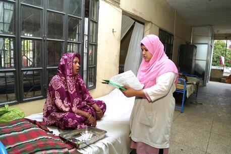 Razia Sultana Tania, a midwife in rural Bangladesh with specialized training supported by UNICEF, consults with a patient.