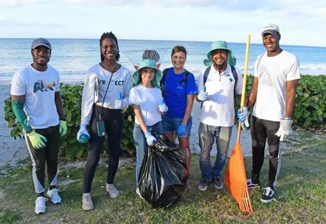 UNICEF Youth Advocate Maria, center, with fellow climate activists, led an environmental clean-up in Oistins, a fishing town in Barbados, in March 2024.