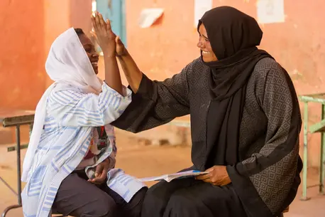 Walaa, 15, meets with Noha, a counselor at the UNICEF-supported Alshargia safe learning space in Kassala State, Sudan.