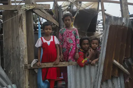 Taieba, 8, Mim, 8, Jannatul, 13, and Shahadat, 3, stand among what remains of their home in Patuakhali, Bangladesh, which was destroyed by Cyclone Remal.