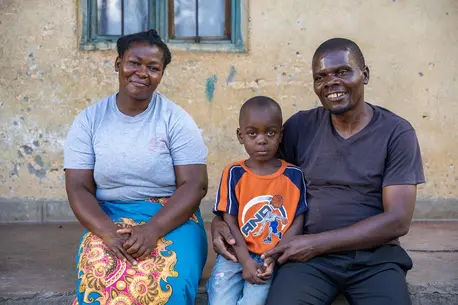 On Jan. 31, 2024, a family sit on the porch of their house in Lilongwe District, Malawi.