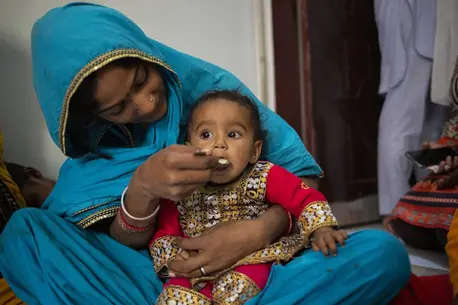 A mother feeds her 10-month-old daughter at a UNICEF nutrition counseling session on complementary feeding on Feb. 29, 2024, in Lyari, Karachi, Sindh, Pakistan.