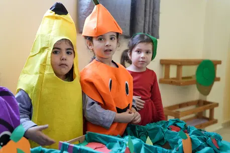 Young children learn about good nutrition at a UNICEF-supported learning space in Lebanon.