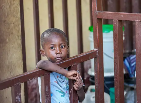 Displaced by violence, a boy stands in a hallway of a school being used as an emergency shelter in Port-au-Prince, Haiti.