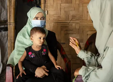 On July 15, 2024, UNICEF-trained Rohingya community nutrition volunteer Taslima visits Noor Bibi, 28, to provide nutrition counseling and to assess the nutritional status of her daughter Jishan, 2, at their shelter in the Rohingya refugee camps in Cox’s Bazar, Bangladesh.
