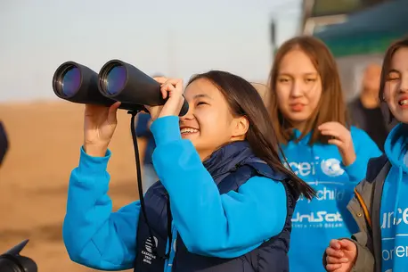 Girls in Kazakhstan launch a cutting-edge nanosatellite into the stratosphere using a helium balloon.