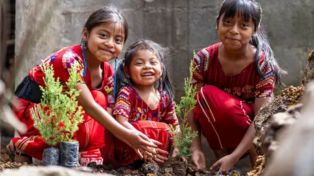 On September 28, 2023, in Quiche, Guatemala a group of indigenous girls plant trees outside their home.