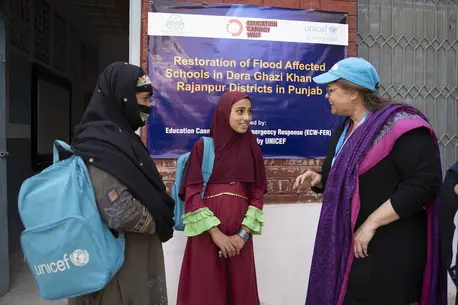 Muqadas, 12, and her mother, Salma, 35, talk with a UNICEF staff member at the ALP center in Dera Ghazi Khan, Punjab, Pakistan.