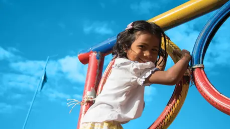 A girl enjoys playing in the playground at Srae Tahen primary school.
