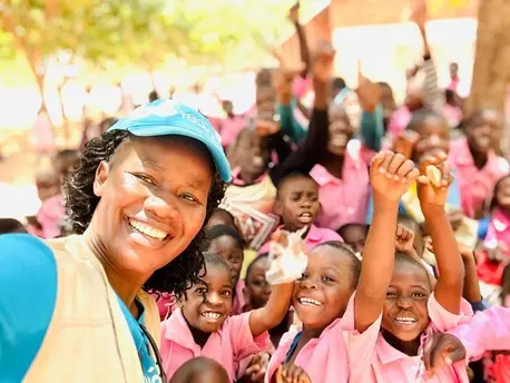 Students celebrate the K.I.N.D. Fund's delivery of new desks to their school in Mzimba District, Malawi on Oct. 23, 2024.