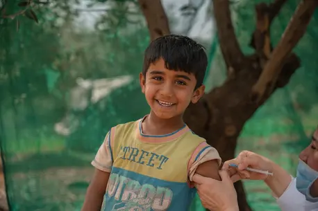 On April 22, 2024, Rayyan receives an MMR vaccine from a UNICEF-supported health worker in the informal tented settlement in Jarish, north Jordan where he lives. 