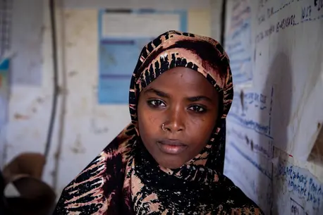 In the drought-stricken Afar region of north-eastern Ethiopia, 16-year-old Fatuma, leans against the white board in her classroom. She is in school instead of in an early marriage thanks to child protection programs supported by UNICEF.