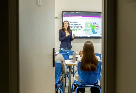 Angelika, a chemistry and biology teacher who helped developed the Pi-station learning platform to help Ukrainian students overcome language barriers to learning, instructs students in a classroom in Warsaw.