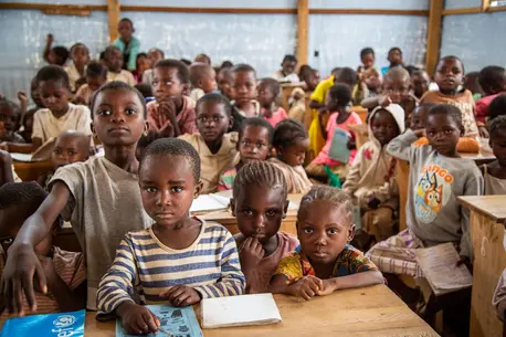 Students in a temporary learning space for displaced children in Kikumbe Village, Democratic Republic of the Congo.
