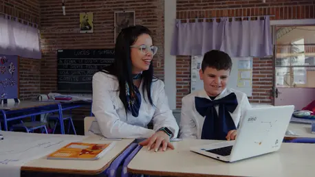 José, 10, and his teacher Lorena, work with an Accessible Digital Textbook (ADT) at a school in Rocha, Uruguay. An innovative partnership between OpenAI and UNICEF is exploring how AI can help make digital textbooks accessible for all children, including students with disabilities.