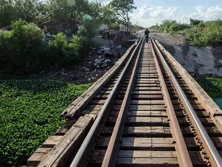 A lonely figure walks the tracks on the outskirts of Reynosa, Mexico, across the Rio Grande from McAllen, Texas.