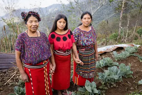 Juana Corio Raymundo, 66, with her daughter Juana Brito Corio, 38, and granddaughter Cecilia, 14, in their garden in the village of La Pista Nebaj, Quiché, Guatemala.