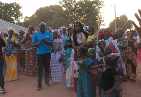 Mothers and children meet with UNICEF staff in Djende, Senegal.