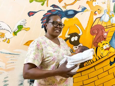 Nurse holding infant in neonatal department in Central African Republic