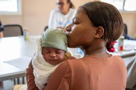A mother in South Africa holds her newborn baby.