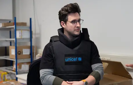 UNICEF Ambassador Doctor Mike samples UNICEF safety gear during visit to the Copenhagen supply warehouse.