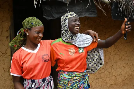 Friends Aicha and Asseta take a selfie in the village of Koda Dioulabougou in southwestern Cote d’Ivoire.