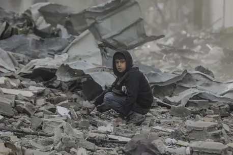 Ten-year-old Qusay searches in the wreckage of his home in in the Al-Touam area in the northern Gaza Strip.