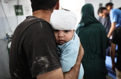 On May 22, 2025, Fares Nassar, 8 months old, receives treatment at Al-Awda Hospital in Nuseirat camp after an airstrike targeted the Al-Hasayneh School, housing displaced Palestinians.