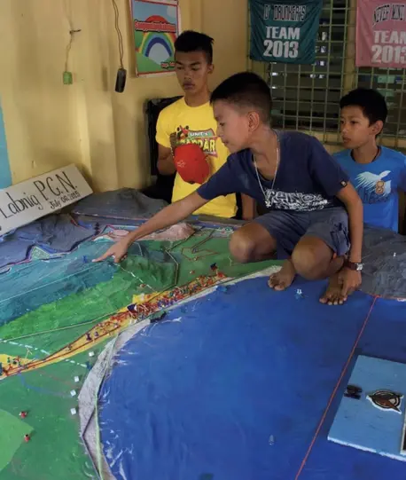 Adolescents in the Philippines participate in 3D hazard mapping.
