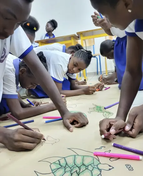 School children in Malabo, Equatorial Guinea, work on a group project for Earth Day.
